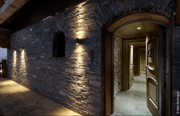 Entrance with stone wall and front door in Courchevel